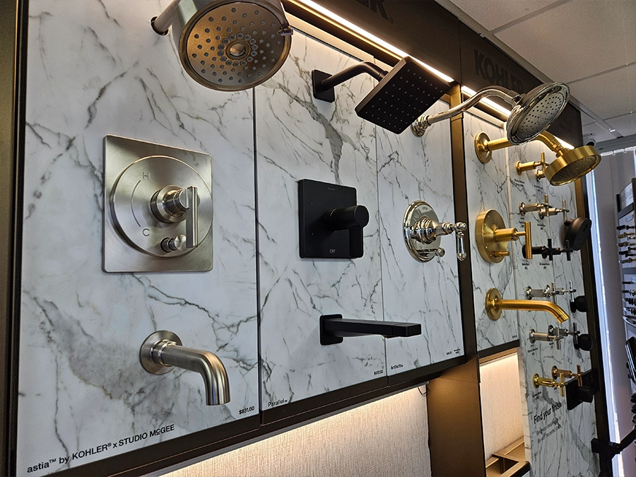 Shower heads and plumbing finishes displayed in the Unique BKB showroom